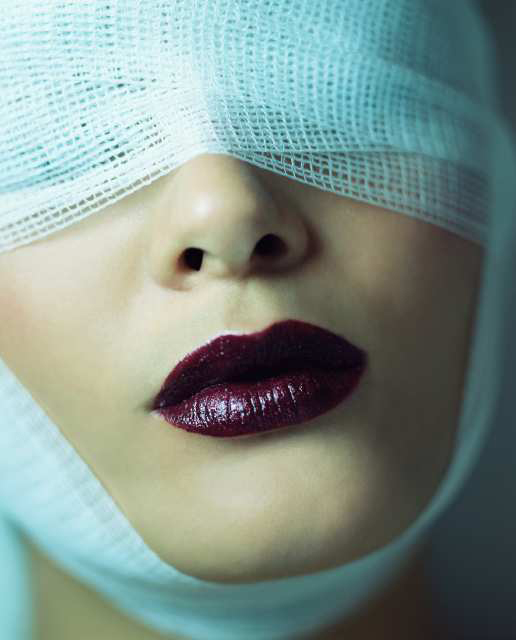 Woman wearing bandage and lipstick